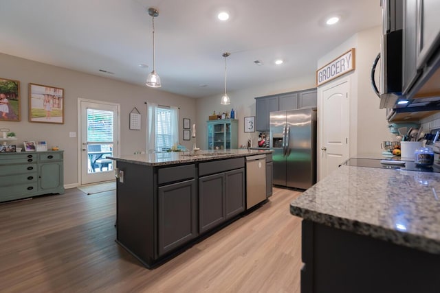 133 Kirkstall Way, Georgetown, KY 40324 - kitchen with appliances with stainless steel finishes, light wood-type flooring, a center island, gray cabinetry, and light stone counters