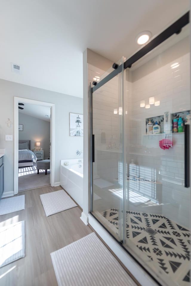 133 Kirkstall Way, Georgetown, KY 40324 - bathroom featuring a garden tub, ensuite bathroom, a shower stall, wood finished floors, and baseboards