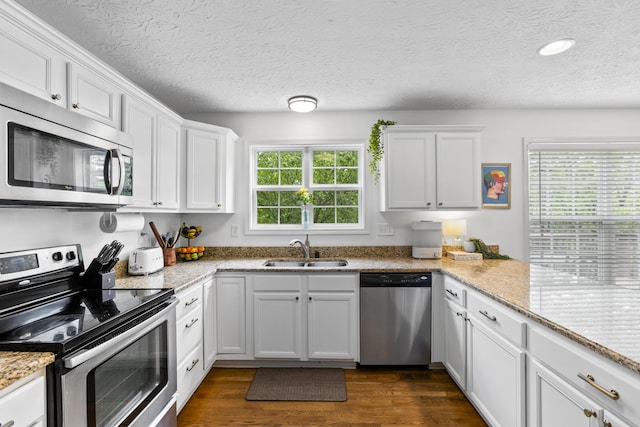 481 Alderbrook Way, Lexington, KY 40515 - kitchen with stainless steel appliances, a sink, white cabinets, dark wood-type flooring, and a textured ceiling
