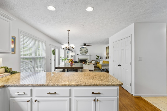 481 Alderbrook Way, Lexington, KY 40515 - kitchen featuring a peninsula, a chandelier, white cabinetry, pendant lighting, and recessed lighting