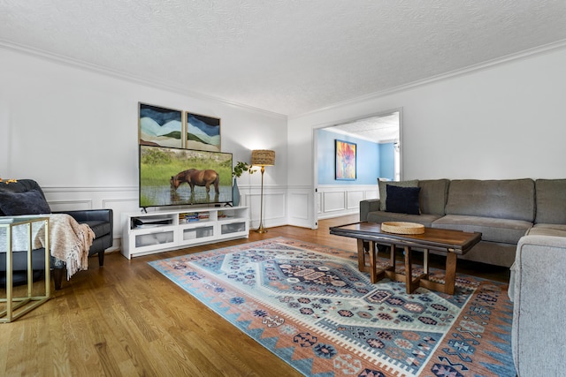 481 Alderbrook Way, Lexington, KY 40515 - living room featuring crown molding, wood finished floors, a textured ceiling, a wainscoted wall, and a decorative wall