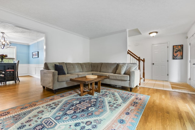 481 Alderbrook Way, Lexington, KY 40515 - living room featuring wood finished floors, a textured ceiling, a chandelier, stairway, and ornamental molding