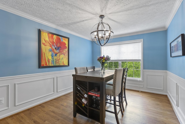 481 Alderbrook Way, Lexington, KY 40515 - dining room featuring a chandelier, a wainscoted wall, wood finished floors, crown molding, and a decorative wall