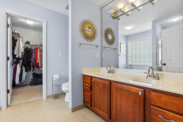 481 Alderbrook Way, Lexington, KY 40515 - full bathroom featuring a textured ceiling, double vanity, toilet, a spacious closet, and tile patterned floors