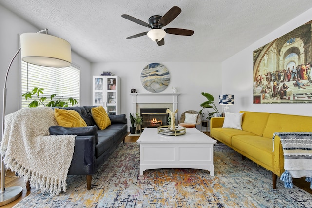 481 Alderbrook Way, Lexington, KY 40515 - living room with ceiling fan, a textured ceiling, and a warm lit fireplace