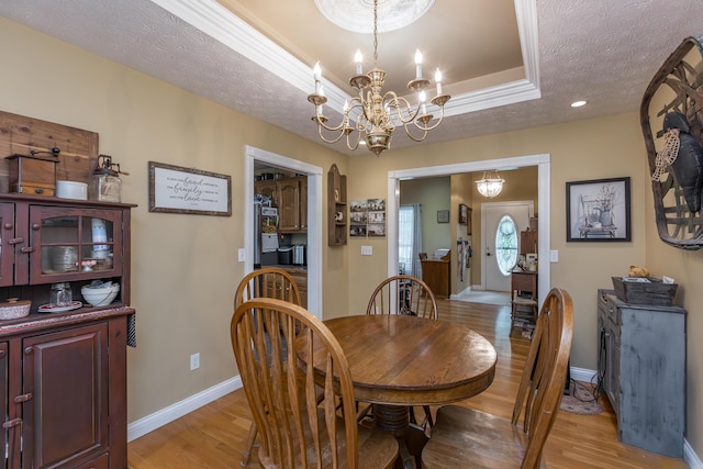 53 Douglas Ave, Stanford, KY 40484 - dining space with light wood finished floors, a chandelier, baseboards, a textured ceiling, and a tray ceiling