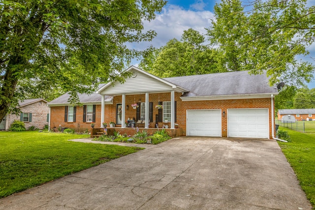 53 Douglas Ave, Stanford, KY 40484 - view of front of home featuring covered porch, brick siding, an attached garage, concrete driveway, and a shingled roof