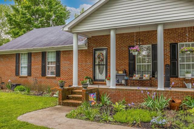 53 Douglas Ave, Stanford, KY 40484 - view of exterior entry featuring covered porch, brick siding, and a yard