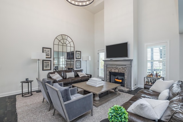 2605 Lucca Pl, Lexington, KY 40509 - living area featuring dark wood-type flooring, baseboards, a towering ceiling, and a fireplace