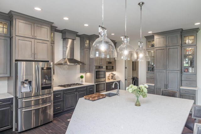 2605 Lucca Pl, Lexington, KY 40509 - kitchen featuring appliances with stainless steel finishes, a sink, independent washer and dryer, recessed lighting, and wall chimney exhaust hood