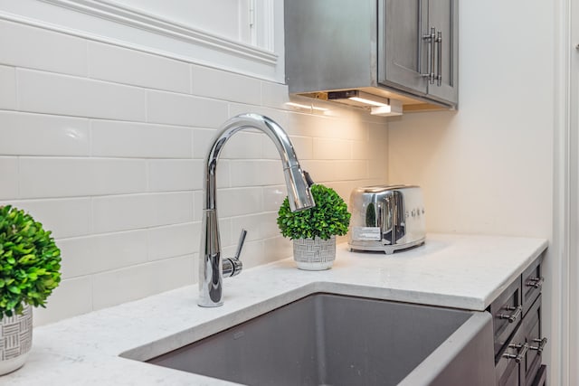 2605 Lucca Pl, Lexington, KY 40509 - kitchen view of tasteful backsplash, a sink, and light stone countertops