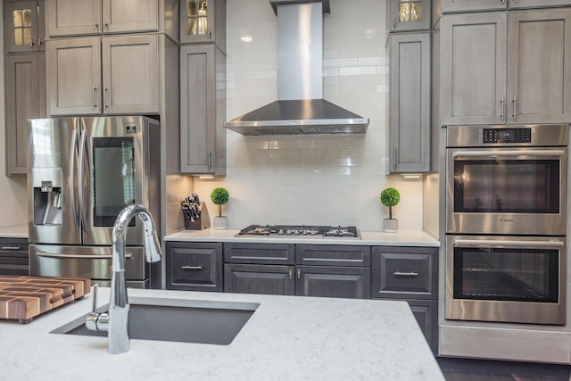 2605 Lucca Pl, Lexington, KY 40509 - kitchen with appliances with stainless steel finishes, wall chimney range hood, backsplash, glass insert cabinets, and a sink