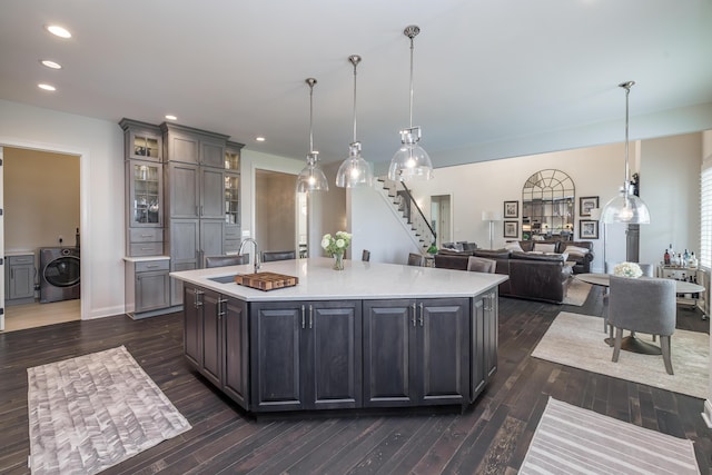 2605 Lucca Pl, Lexington, KY 40509 - kitchen featuring washer / dryer, a sink, light countertops, dark wood-style floors, and recessed lighting