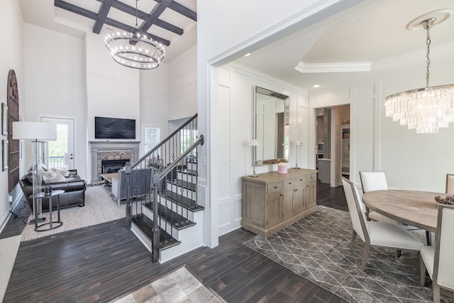 2605 Lucca Pl, Lexington, KY 40509 - stairway featuring a chandelier, coffered ceiling, wood finished floors, a fireplace, and a high ceiling