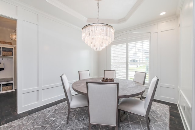 2605 Lucca Pl, Lexington, KY 40509 - dining area featuring a decorative wall, a chandelier, ornamental molding, dark wood finished floors, and a raised ceiling