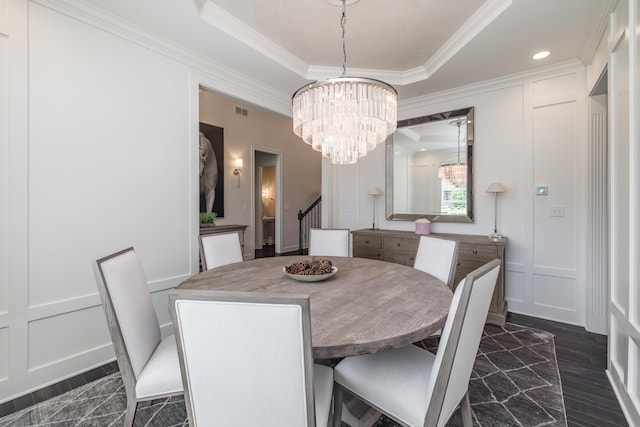 2605 Lucca Pl, Lexington, KY 40509 - dining area featuring a decorative wall, a chandelier, ornamental molding, a tray ceiling, and dark wood finished floors