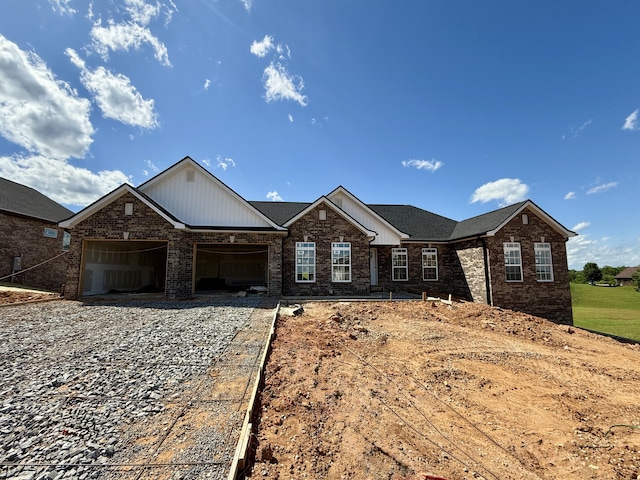 77 Sunrise Path, Somerset, KY 42503 - view of front facade featuring a garage, brick siding, and gravel driveway