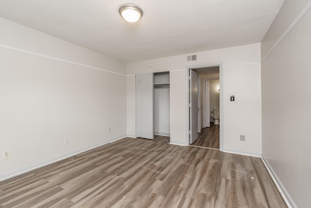 1092 Armstrong Mill Rd Unit A, Lexington, KY 40517 - unfurnished bedroom with wood finished floors, a closet, and baseboards