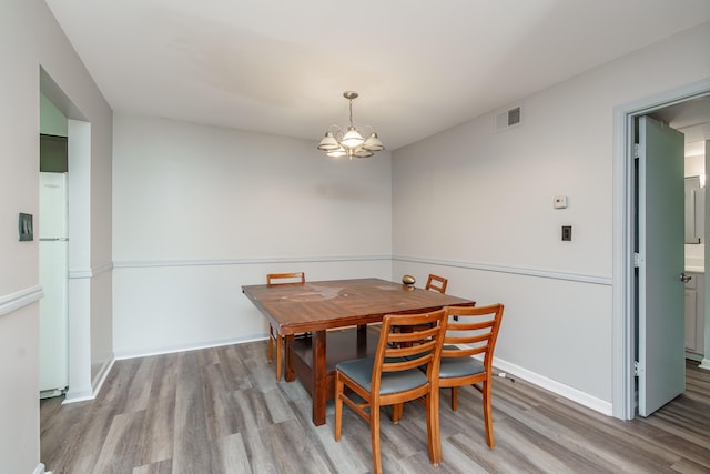 1092 Armstrong Mill Rd Unit A, Lexington, KY 40517 - dining space with wood finished floors, a chandelier, and baseboards