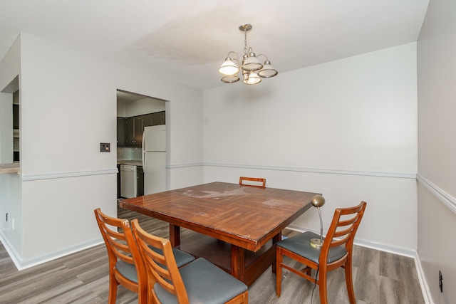 1092 Armstrong Mill Rd Unit A, Lexington, KY 40517 - dining space with a chandelier, wood finished floors, and baseboards