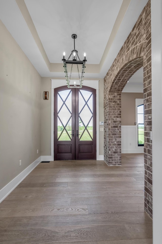1408 Champion Way, Richmond, KY 40475 - entrance foyer with arched walkways, a chandelier, a tray ceiling, french doors, and wood finished floors