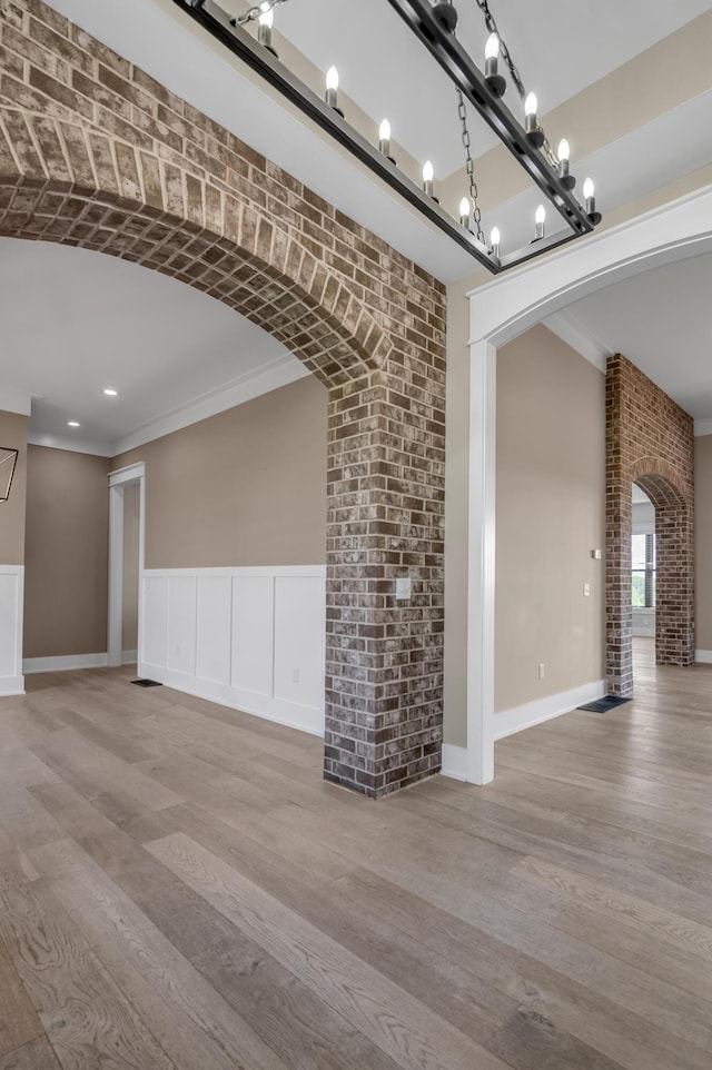 1408 Champion Way, Richmond, KY 40475 - unfurnished living room featuring arched walkways, wood finished floors, ornamental molding, and baseboards