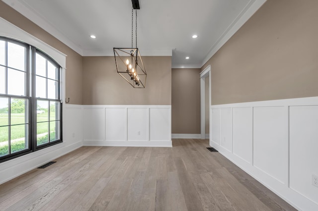 1408 Champion Way, Richmond, KY 40475 - unfurnished dining area featuring a decorative wall, light wood-type flooring, healthy amount of natural light, wainscoting, and a chandelier