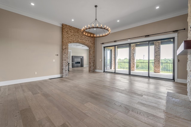 1408 Champion Way, Richmond, KY 40475 - unfurnished living room with a chandelier, ornamental molding, light wood finished floors, baseboards, and a fireplace