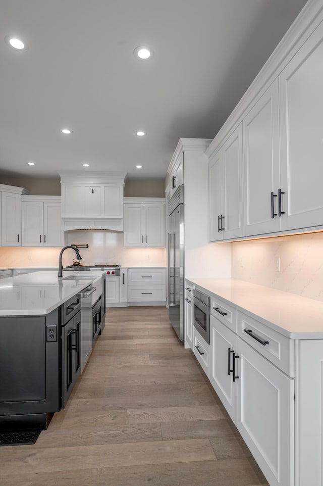 1408 Champion Way, Richmond, KY 40475 - kitchen with built in appliances, white cabinets, recessed lighting, decorative backsplash, and light countertops
