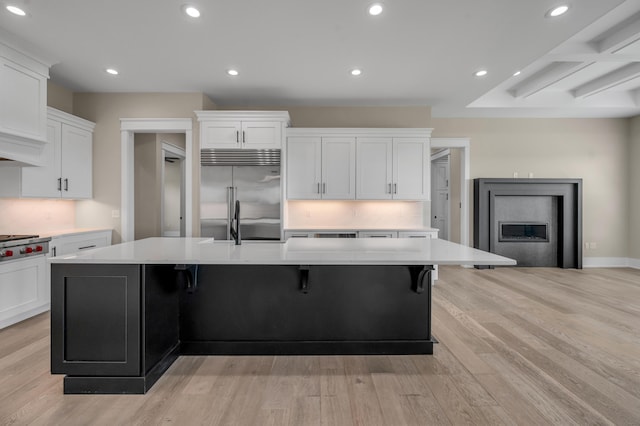 1408 Champion Way, Richmond, KY 40475 - kitchen featuring appliances with stainless steel finishes, light countertops, white cabinets, light wood-style floors, and a spacious island
