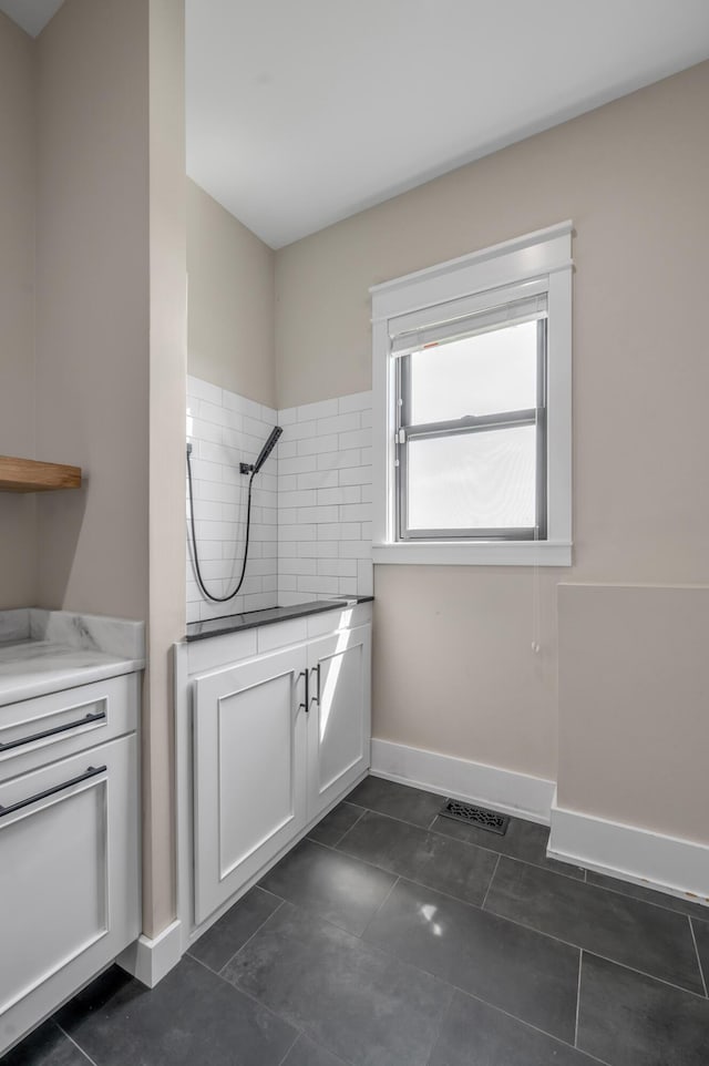 1408 Champion Way, Richmond, KY 40475 - laundry area with baseboards and dark tile patterned flooring