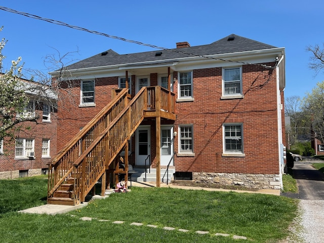 108 Cochran Rd, Lexington, KY 40502 - back of house featuring brick siding, a lawn, a chimney, stairs, and roof with shingles