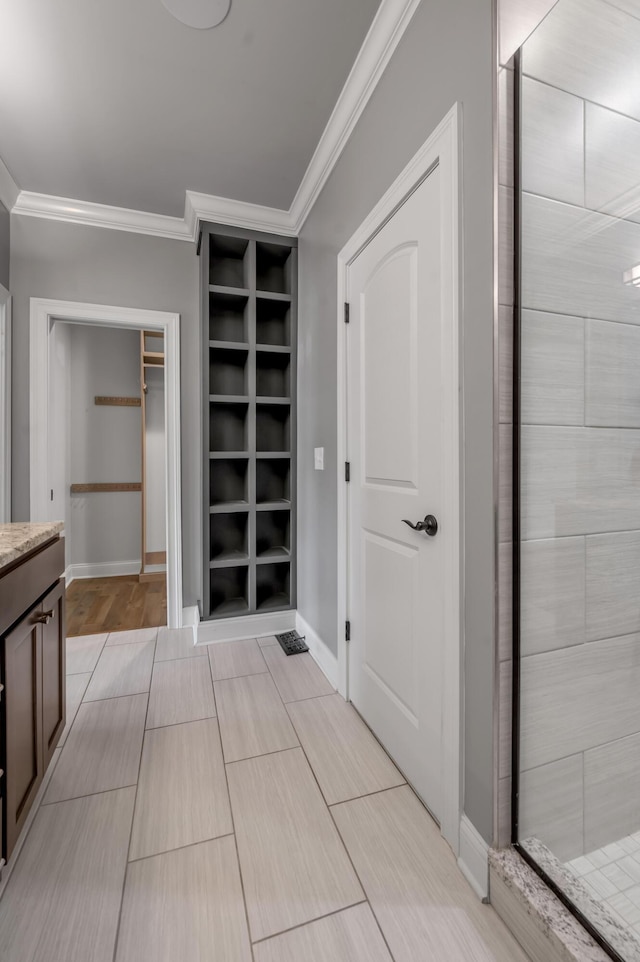 2131 Patchen Lake Ln, Lexington, KY 40505 - bathroom featuring ornamental molding, a walk in closet, vanity, a stall shower, and baseboards