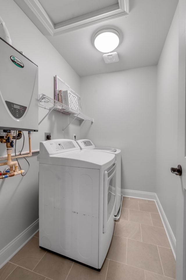 2131 Patchen Lake Ln, Lexington, KY 40505 - laundry room featuring tankless water heater, separate washer and dryer, light tile patterned floors, and baseboards