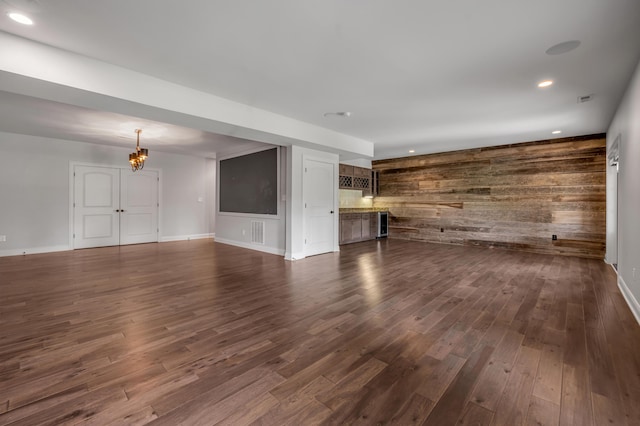 2131 Patchen Lake Ln, Lexington, KY 40505 - unfurnished living room featuring wood walls, dark wood-style floors, recessed lighting, a chandelier, and baseboards