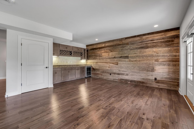 2131 Patchen Lake Ln, Lexington, KY 40505 - unfurnished living room featuring wine cooler, a bar, wood walls, dark wood finished floors, and recessed lighting