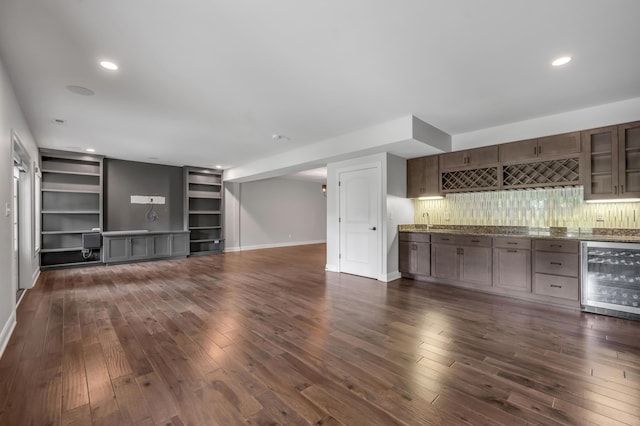 2131 Patchen Lake Ln, Lexington, KY 40505 - unfurnished living room featuring beverage cooler, bar with sink, dark wood-style floors, baseboards, and recessed lighting