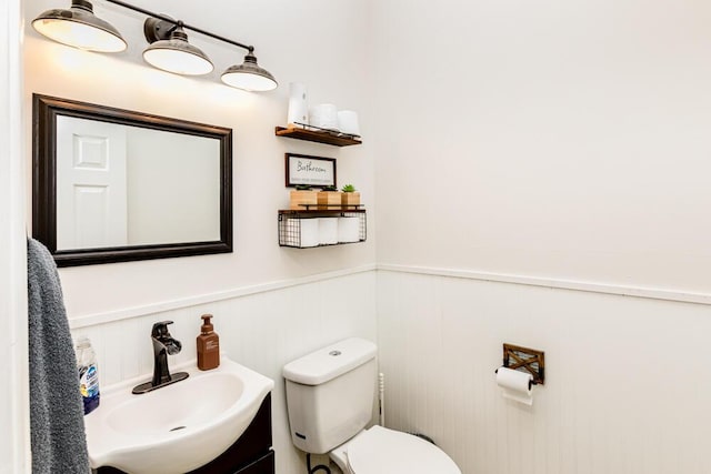 186 Santa Barbara Blvd, Georgetown, KY 40324 - half bathroom with toilet, a wainscoted wall, vanity, and a decorative wall