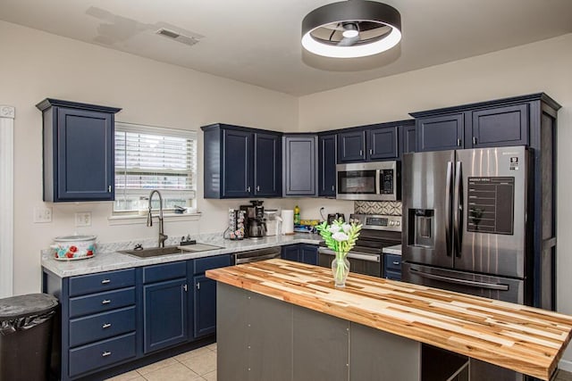 186 Santa Barbara Blvd, Georgetown, KY 40324 - kitchen with a sink, appliances with stainless steel finishes, butcher block countertops, blue cabinets, and light tile patterned floors