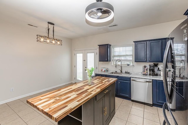 186 Santa Barbara Blvd, Georgetown, KY 40324 - kitchen with stainless steel dishwasher, freestanding refrigerator, a sink, and light tile patterned flooring