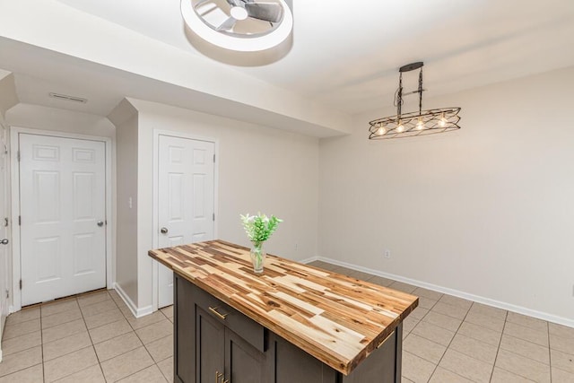 186 Santa Barbara Blvd, Georgetown, KY 40324 - kitchen with butcher block counters, light tile patterned floors, baseboards, and a kitchen island