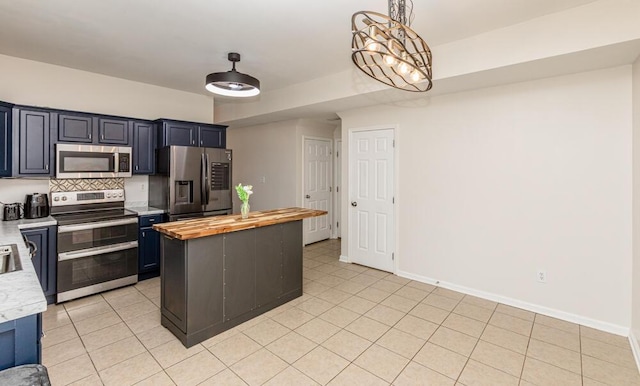186 Santa Barbara Blvd, Georgetown, KY 40324 - kitchen featuring appliances with stainless steel finishes, wooden counters, backsplash, a kitchen island, and light tile patterned flooring