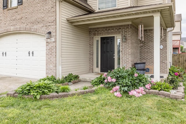 186 Santa Barbara Blvd, Georgetown, KY 40324 - view of exterior entry with brick siding, a garage, and a yard