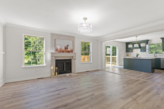 3261 Royal Troon Rd, Lexington, KY 40509 - unfurnished living room with healthy amount of natural light, ornamental molding, light wood finished floors, a chandelier, and a fireplace