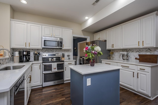 3789 Ridge View Way, Lexington, KY 40509 - kitchen with stainless steel appliances, a sink, backsplash, white cabinetry, and a center island