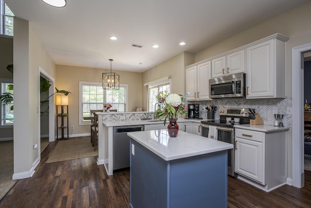 3789 Ridge View Way, Lexington, KY 40509 - kitchen featuring stainless steel appliances, a peninsula, white cabinetry, light countertops, and tasteful backsplash