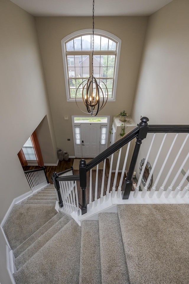3789 Ridge View Way, Lexington, KY 40509 - stairs featuring a chandelier, baseboards, and carpet