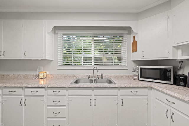 680 Beaumont Ave, Harrodsburg, KY 40330 - kitchen featuring stainless steel microwave, a sink, light countertops, white cabinets, and crown molding