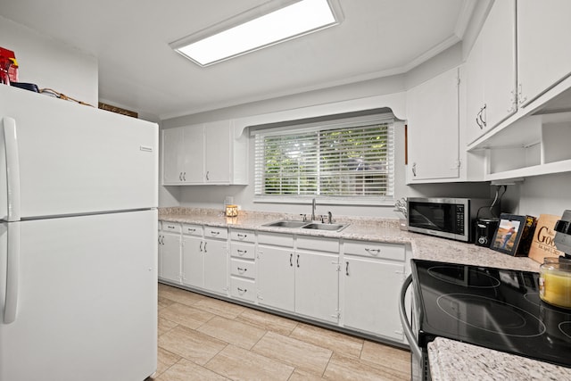 680 Beaumont Ave, Harrodsburg, KY 40330 - kitchen featuring freestanding refrigerator, a sink, electric range, stainless steel microwave, and light countertops