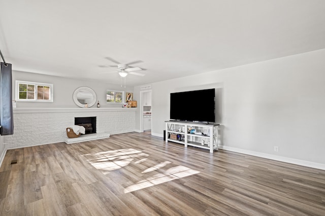 680 Beaumont Ave, Harrodsburg, KY 40330 - living room with ceiling fan, wood finished floors, a brick fireplace, and baseboards